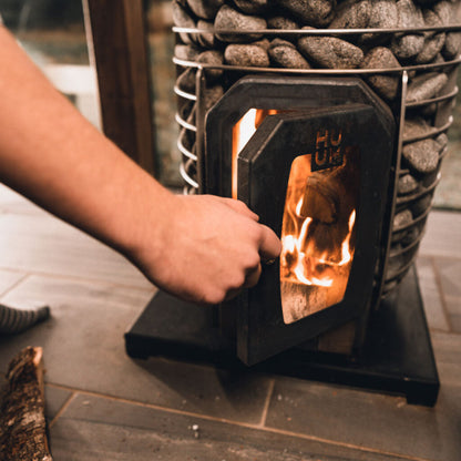 HUUM HIVE Wood 17 wood-burning sauna stove with fire